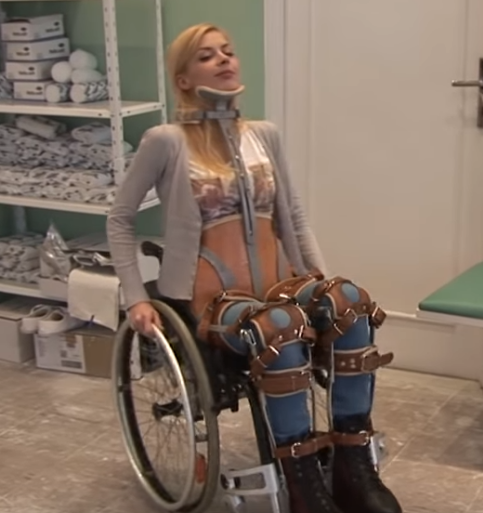 FREE PREVIEW: Amy Fully Braced - Wearing braces on both of her legs and a milwaukee brace forces Amy to use a wheelchair.