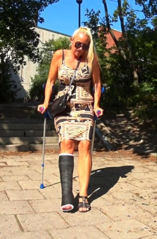 Nadja SLC #2 - Nadja is on her way out for a walk for the first time since she hurt her ankle. Her right leg is in a black short leg cast and she must now use crutches to get forward. She take the chort cut over the schoolyard down to the card but...